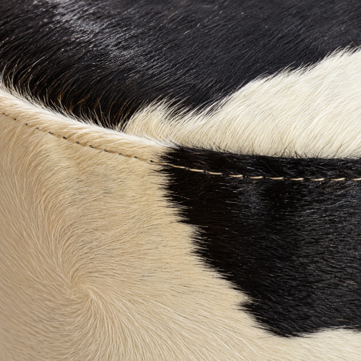 Cowhide Footstool | Black & White Hair-On – Brazilian Cowhide, Eucalyptus Legs — close-up of the surface texture